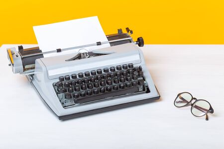 Workplace of the manager of the secretary and business typewriter and glasses are on the table on a...