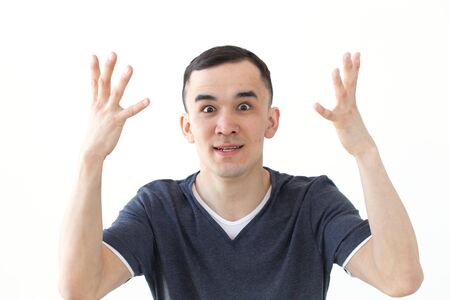 People, gesture and fashion concept - excited angry asian man isolated over whiteの写真素材