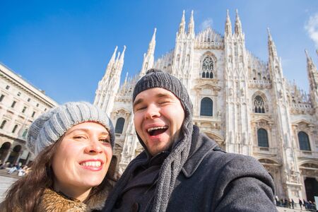Couple taking self portrait in Duomo square in Milan. Traveling and relationship conceptの写真素材