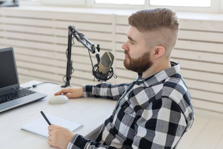 technology, home, music and lifestyle concept - smiling man with laptop and headphones at homeの写真素材