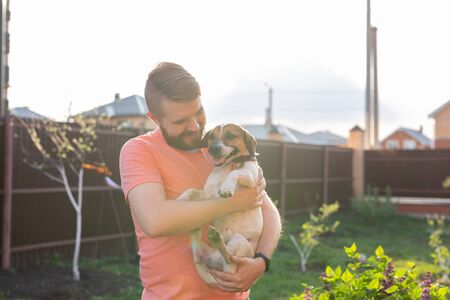 Man holding on hands his lovely jack russell terrier dog.の写真素材