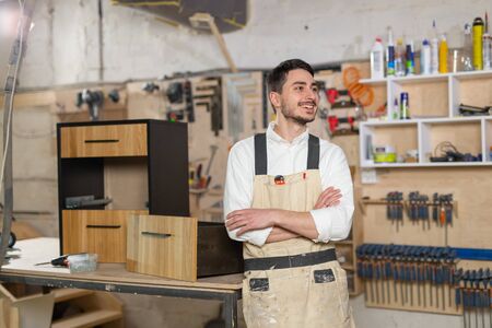 furniture factory, Small-Sized Companies and people concept - Portrait of a smiling male worker at manufacturingの写真素材