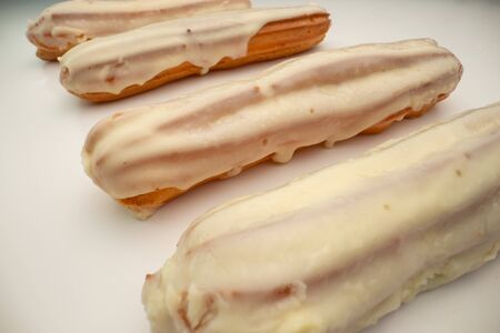 Eclairs with white glaze. Homemade eclairs cakes.の写真素材