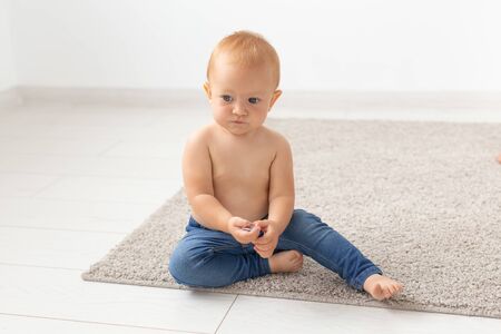 children, people, infancy and age concept - beautiful happy baby at homeの写真素材