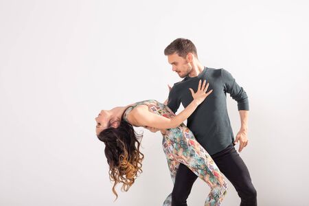 Passionate couple dancing social danse kizomba or bachata or semba or taraxia on white background with copy spaceの写真素材