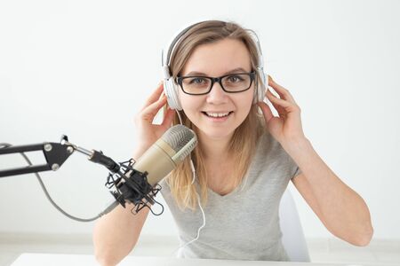 Radio, blogging, broadcast concept - close-up of wwoman dj is working on the radioの写真素材