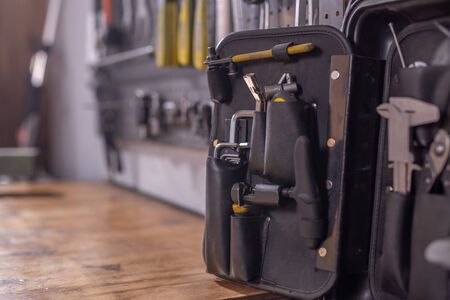 Set of tools, screws, pliers and nuts on a workshop background.の写真素材