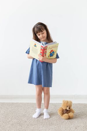 model, seamstress, designer, people concept - child girl in blue dress over the white backgroundの写真素材