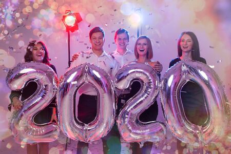 Party, people and new year holidays concept - women and men celebrating new years eve 2020の写真素材