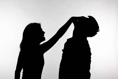 Domestic violence and abuse concept - Silhouette of a woman slapping a manの写真素材