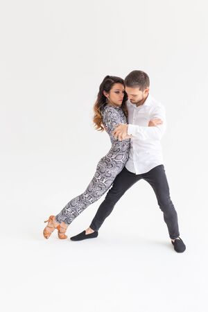 Passionate couple dancing social danse kizomba or bachata or tango or salsa on white backgroundの写真素材