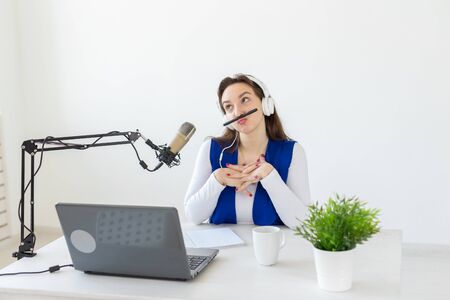 Radio host concept - Portrait of woman radio presenter with headphonesの写真素材