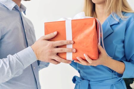 Man and woman holding gift box. Celebrate a happy new year or christmasの写真素材