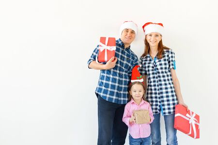 Holidays and celebration concept - Happy family with Christmas presents on white background with copy spaceの写真素材