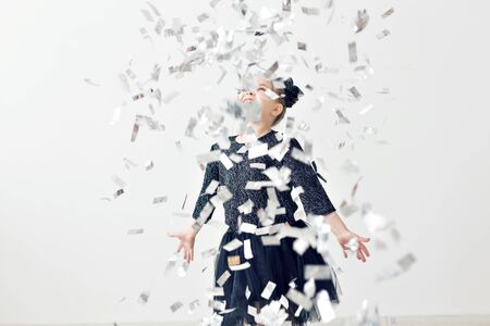 Party, holidays, new year and celebration concept - Female child throwing confetti.
