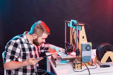 A student man print prototype on 3D printer