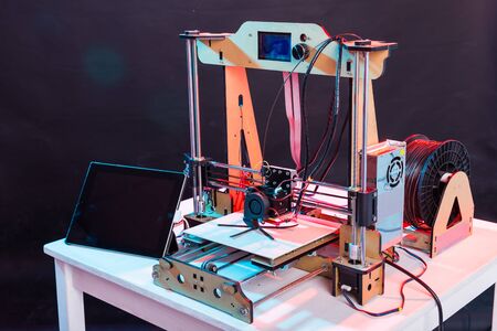 3d printer working and printing plastic prototype