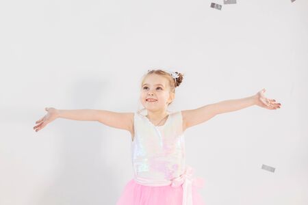 Party, holidays, birthday, new year and celebration concept - Cute child throwing confetti.