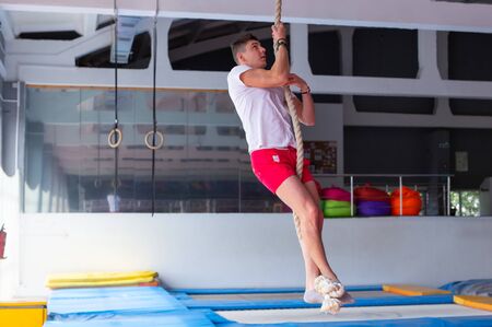 Fitness rope climb exercise in fitness gym workout.の写真素材
