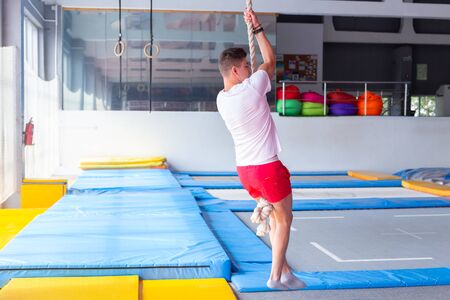 Fitness rope climb exercise in fitness gym workout.の写真素材