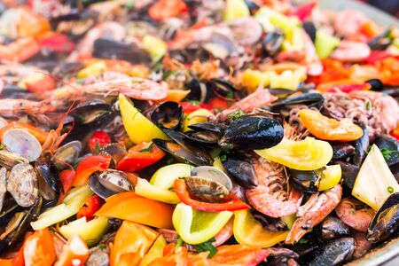 Street food and meal - Spanish paella close-up with shrimp and clamsの写真素材