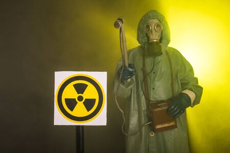 Radiation and danger concept - Man in the gas mask and chemical suit. The worker doing measure radioactivityの写真素材