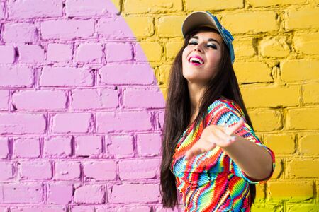 Street dance, freestyle and jazz funk concept - Beautiful girl dancing hip-hop over brick wall with copy space.の写真素材