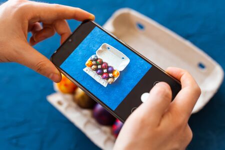 Holidays, tradition, technology and people concept - close up of man hands with smartphone taking...
