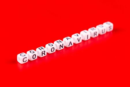 Pandemic and virus concept - Coronavirus word made of white blocks. Coronavirus text on red background.の写真素材