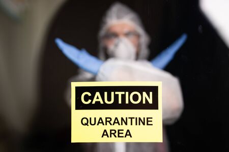 Man in protective white overalls, mask and glasses on his face. Coronavirus, pandemic, flu and...
