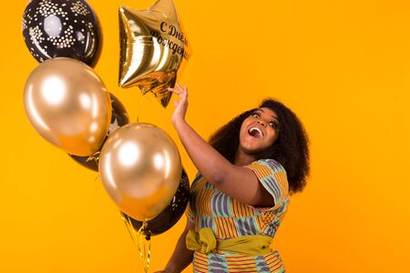 Holidays, party and fun concept - Portrait of smiling young African-American young woman looking...