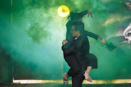 Pasadoble, latin solo dance and contemporary dance - Handsome man and woman dancing into smoke cloud.の写真素材