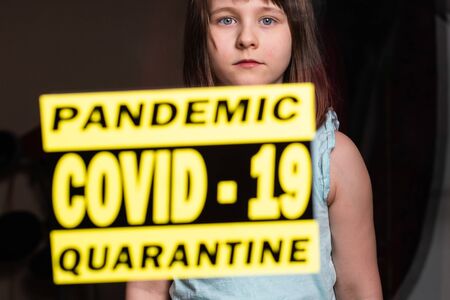 Stay at home. Sad lonely child isolation in quarantine. Concept quarantine, prevention COVID-19, Coronavirus outbreak situation.の写真素材