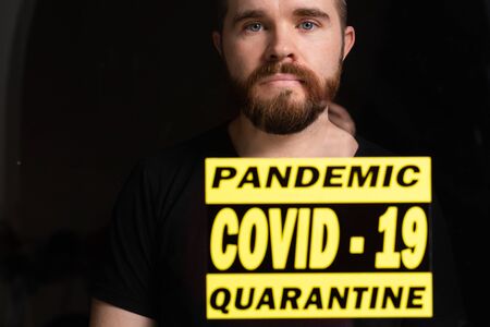 Stay at home. Sad lonely man isolation in quarantine. Concept quarantine, prevention COVID-19, Coronavirus outbreak situation.の写真素材