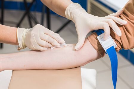Covid-19, pandemic concept - Close-up of doctor takes blood on the analysis.の写真素材