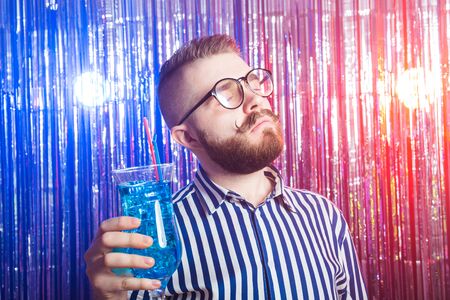 Alcoholism, fun and fool concept - Drunk crazy guy at party in a nightclub.