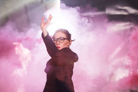 Pasadoble, latin solo dance and contemporary dance - Young beautiful female dancing into smoke cloud
