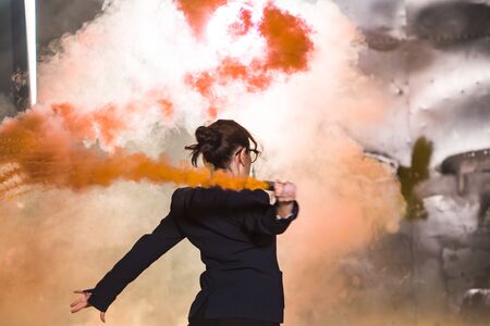 Pasadoble, latin solo dance and contemporary dance - Young beautiful female dancing into smoke cloudの写真素材