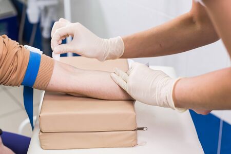 Covid-19, pandemic concept - Close-up of doctor takes blood on the analysis.の写真素材