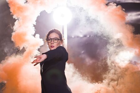 Pasadoble, latin solo dance and contemporary dance - Young beautiful female dancing into smoke cloud
