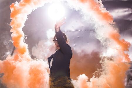 Pasadoble, latin solo dance and contemporary dance - Young beautiful female dancing into smoke cloudの写真素材