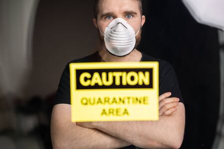 Coronavirus, quarantine, covid-19 and pandemic concept. Sad and sick man of corona virus looking through the window.の写真素材