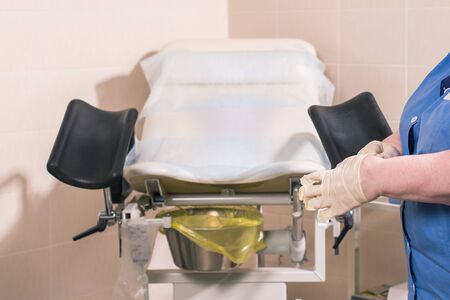 Close-up of doctor hand holds gynecological examination instruments. Gynecologist working in the obstetrics and gynecology department. Medical concept.の写真素材