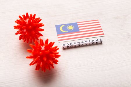 Abstract virus strain model of 2019-nCoV middle East respiratory syndrome coronavirus or coronavirus COVID-19 with text and flag Malaysia on white background. Virus pandemic protection concept.の写真素材