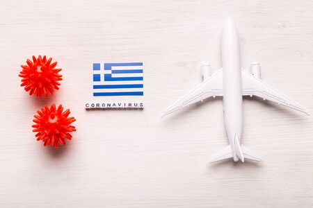 Flight ban and closed borders for tourists and travelers with coronavirus covid-19. Airplane and flag of Greece on a white background. Coronavirus pandemic.の写真素材