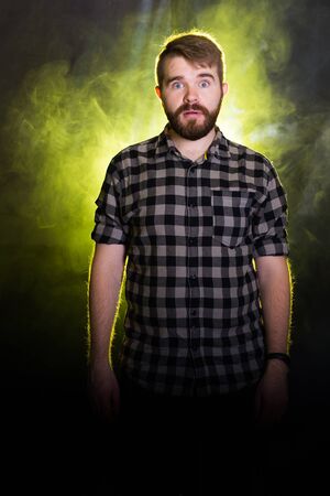 Emotional stunned handsome male has mustache and beard, being shocked with sudden raise of prices,...