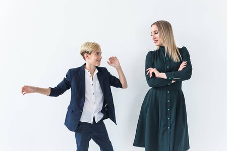 Parenting, family and single parent concept - A happy mother and teen son dancing on white...