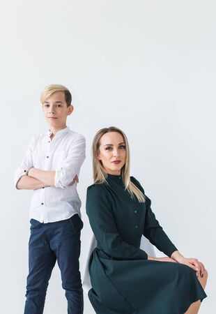 Parenting, family and single parent concept - A happy mother and teen son smiling on white background.の写真素材