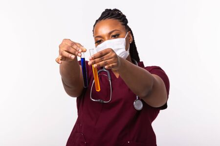 Medical researcher holding test tubes with liquids. Vaccine development, coronavirus, covid-19 and science concept.の写真素材