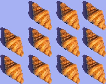 Bakery products pattern with baked croissant. Purple background, top view. Pop art style. Delicious and food.の写真素材